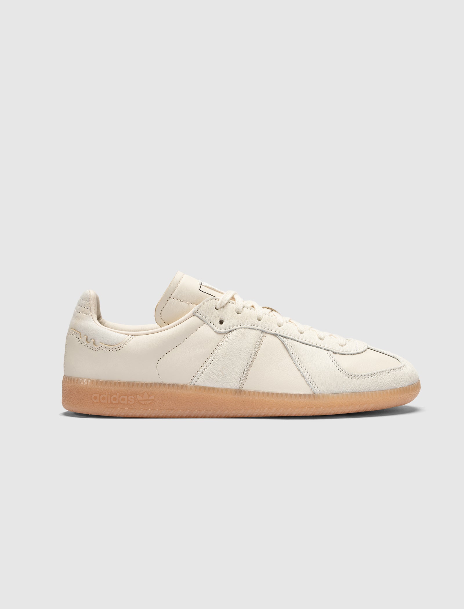 Men's cream leather sneaker with gum sole and minimalist design on white background