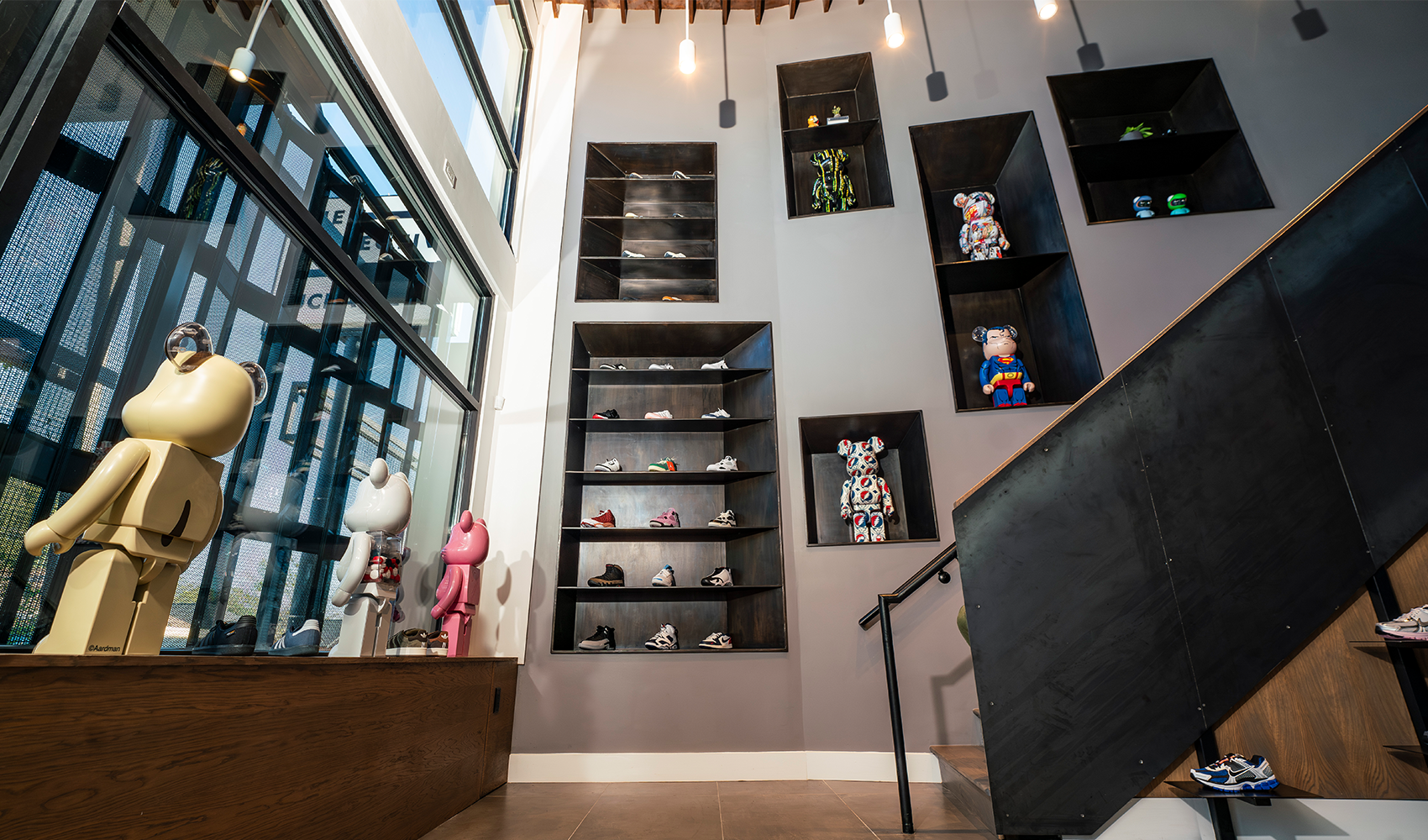 Modern streetwear store interior with collectible bearbrick figures and sneakers on display shelves