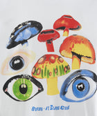 White graphic tee with colorful mushrooms, illustrated eyes, and 'Bueno - it Means Good' text.