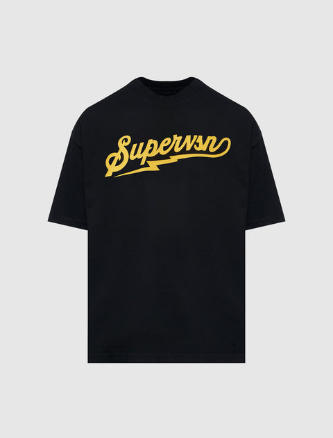 Black streetwear t-shirt with yellow 'Supervsn' script and lightning bolt graphic on chest