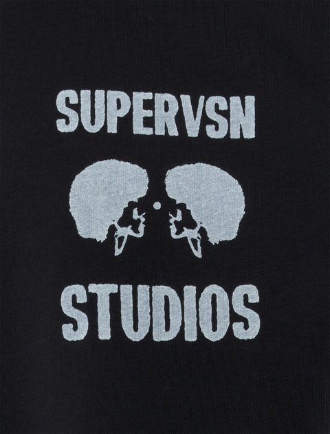 Black streetwear shirt with white SUPERVSN STUDIOS logo and mirrored afro silhouettes