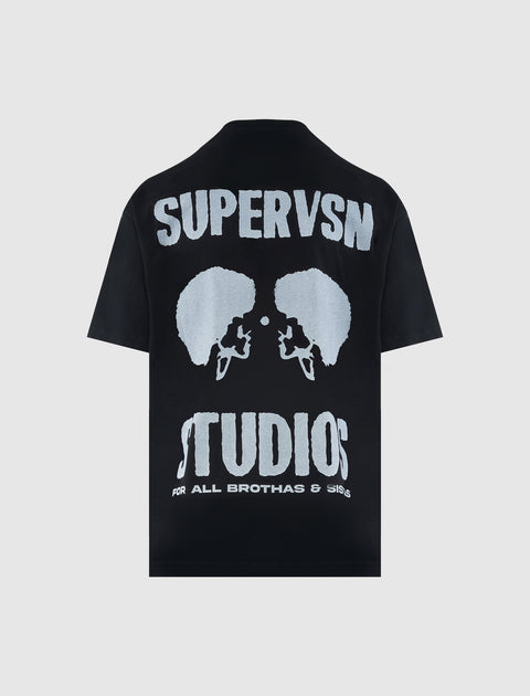 Black short sleeve streetwear t-shirt with bold white 'SUPERVSN STUDIOS' graphic on back.