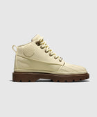 Cream high-top canvas boot with brown lug sole, side view on white background