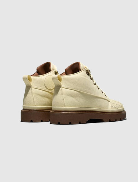 Cream high-top casual boots with chunky brown soles, side and back view on gray background