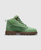 Green suede lace-up boot with embossed side logo and brown lug sole on white background