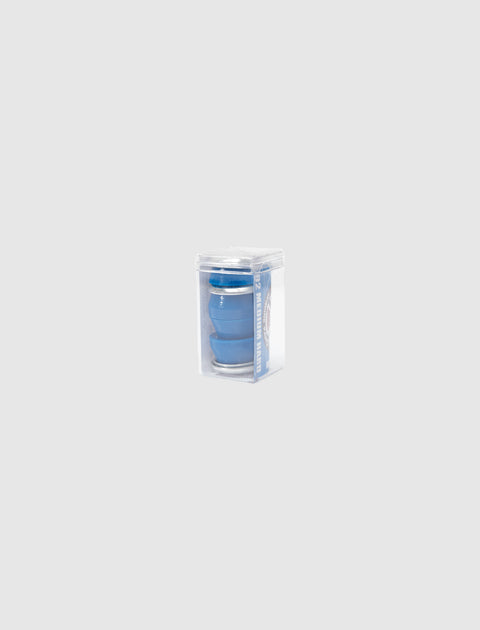 Blue collapsible silicone cup in clear plastic packaging on a light gray background