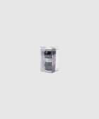 Black skateboard hardware in clear plastic packaging on a plain light background
