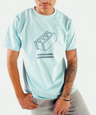 Man wearing light blue streetwear t-shirt with cinder block graphic and tattoo sleeve