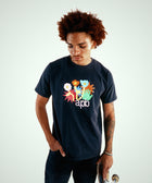 Man wearing black streetwear graphic t-shirt with colorful floral design and holding skateboard