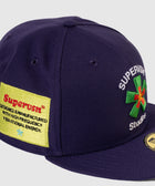 Purple streetwear snapback cap with embroidered patch and logo details on the front and side