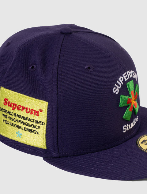 Purple streetwear snapback cap with embroidered patch and logo details on the front and side