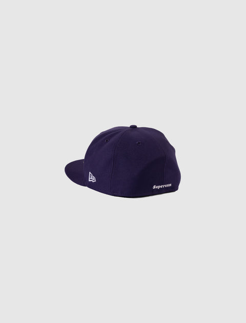 Purple streetwear baseball cap with white embroidery, side and back angled view