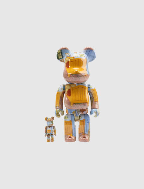 Two art bear brick figures with colorful painted patterns on a plain background