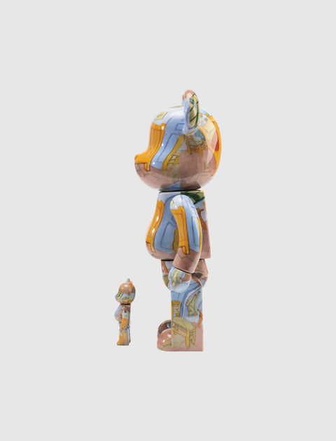 Two colorful bear-shaped collectible toys with abstract patterns, side view on white background.