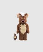 Brown furry collectible figures with white hair and pointy ears on a plain background