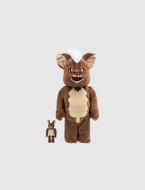 Brown furry collectible figures with white hair and pointy ears on a plain background