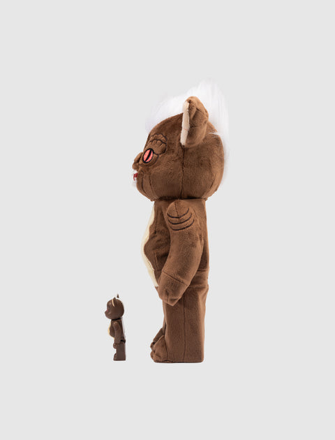Side view of two brown plush and vinyl collectible figures, one large and one small, on a gray background.