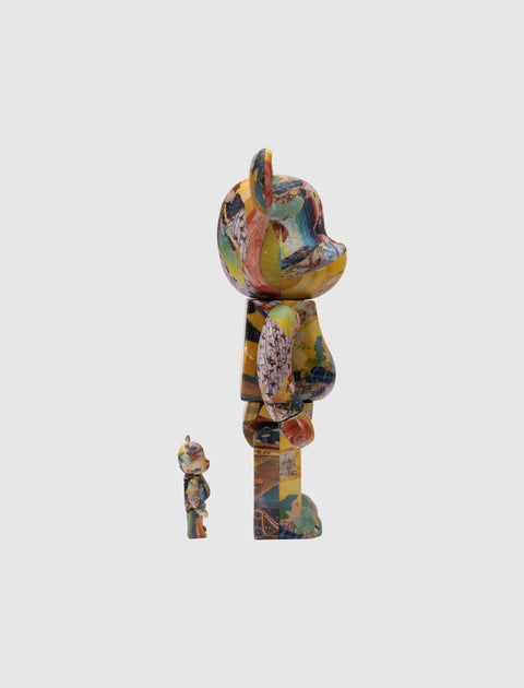 Two multicolor abstract bear-shaped collectible figures side by side on white background