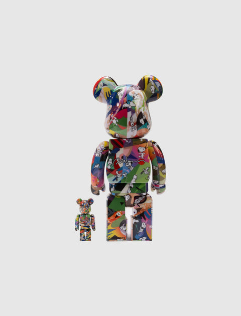 Colorful collectible bear figures with cartoon graphic patterns on plain background
