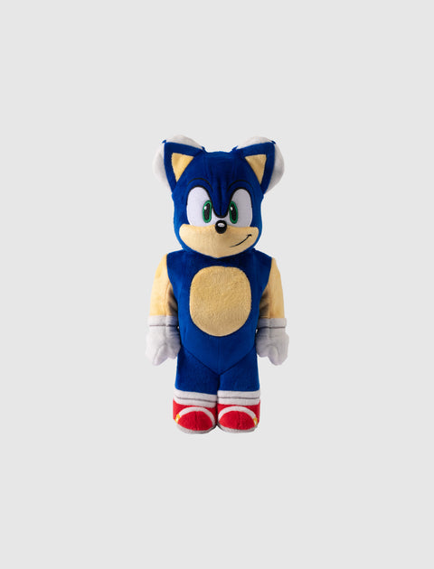 Blue cartoon hedgehog plush toy with red shoes and white gloves on plain background