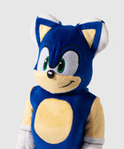 Blue plush toy with green eyes and white gloves, yellow details on chest and ears