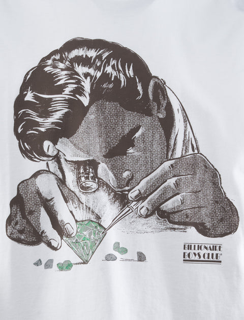 Graphic tee with illustrated man inspecting green gemstone and Billionaire Boys Club logo