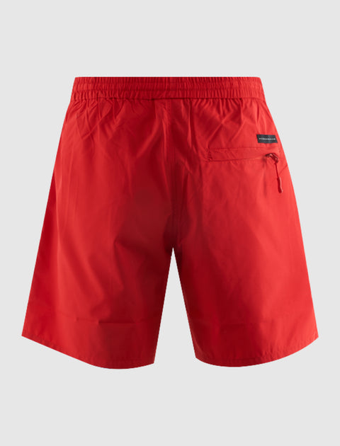 Back view of red men’s streetwear shorts with elastic waistband and zip pocket