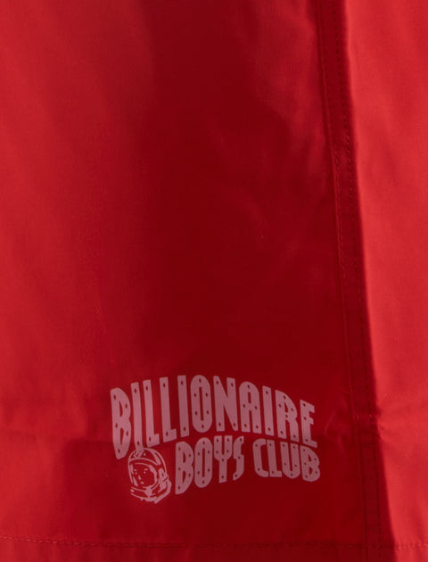 Close-up of red fabric with Billionaire Boys Club logo print and detailed stitching