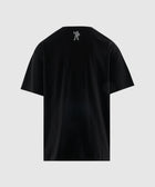 Back view of black men's streetwear t-shirt with small astronaut graphic on upper back