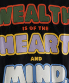Streetwear t-shirt with colorful bold text reading 'Wealth is of the heart and mind' on black fabric