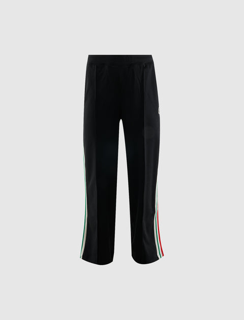 Black men's track pants with green, white, and red side stripes, streetwear style.