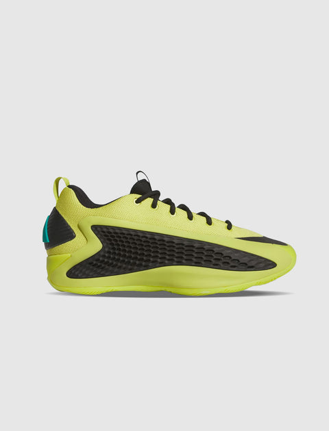 Lime green low-top men's sneaker with black accents and textured side panel on white background