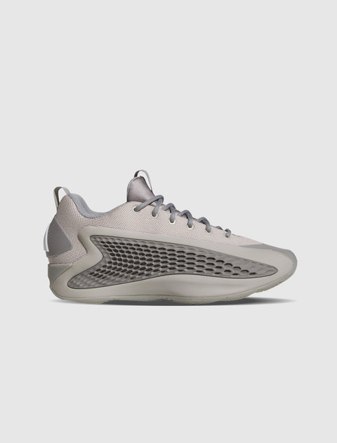 Gray low-top sneaker with mesh panel and textured side sole on white background