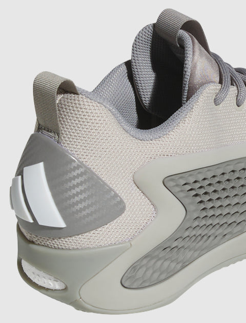 Close-up of a grey mesh athletic sneaker with textured heel and side panel details
