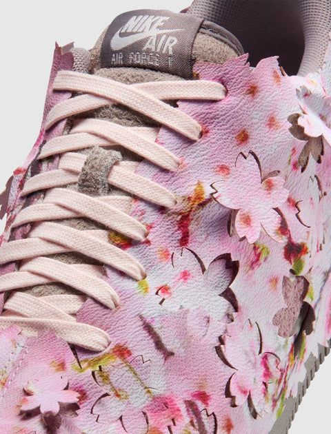 Close-up of Nike Air Force 1 sneaker in pink with cherry blossom floral cutout design