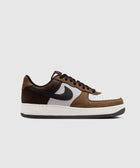 Brown and white men's low-top sneaker with black swoosh, perforated leather, streetwear style