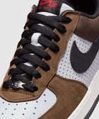 Close-up of Nike Air Force 1 Low sneaker in brown suede and white leather with black laces