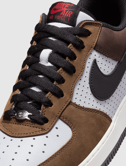 Close-up of Nike Air Force 1 Low sneaker in brown suede and white leather with black laces