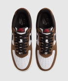 Top view of brown and white Nike Air Force 1 sneakers with black laces on white background