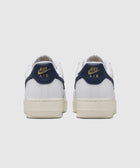 Back view of white Nike Air sneakers with navy and gold accents, men's streetwear shoes