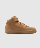 Tan mid-top sneaker with gum sole and ankle strap, minimalist streetwear shoe
