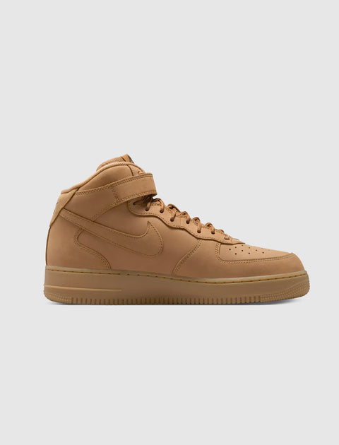 Tan mid-top sneaker with gum sole and ankle strap, minimalist streetwear shoe