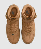 Top view of wheat brown leather Nike Air Force 1 Mid sneakers with perforated toe box.