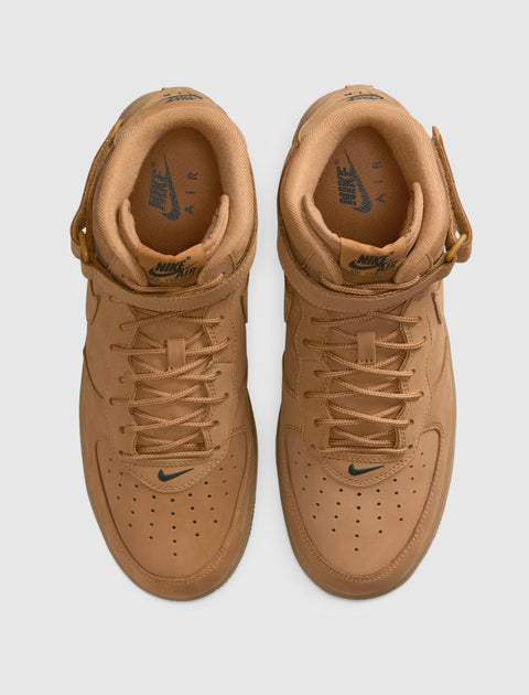 Top view of wheat brown leather Nike Air Force 1 Mid sneakers with perforated toe box.