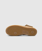 Brown mid-top sneaker outsole with circular tread pattern on white background