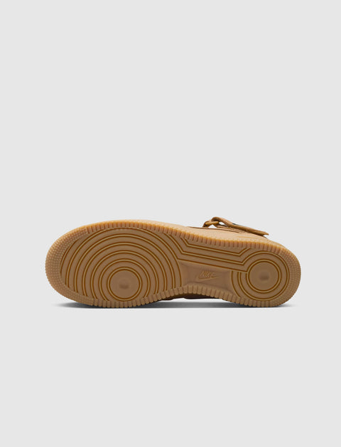 Brown mid-top sneaker outsole with circular tread pattern on white background
