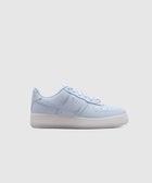 Pale purple low-top sneaker with leather upper, translucent sole, and side logo on white background