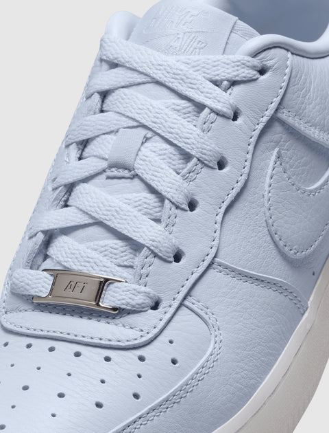 Close-up of pale purple Nike Air Force 1 sneaker with textured leather and white laces