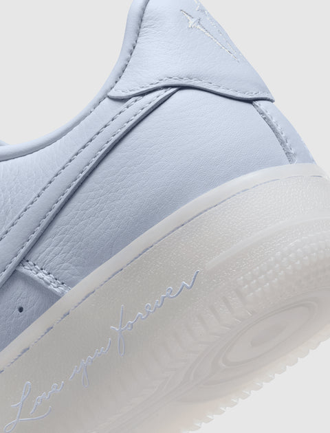 Close-up of pastel purple sneaker heel with 'Love you forever' text and textured sole
