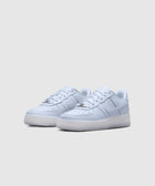 Light purple low-top sneakers with white sole and tonal stitching on a plain background